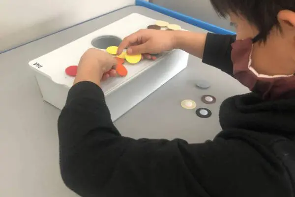 student is working on matching and creating patterns with colors