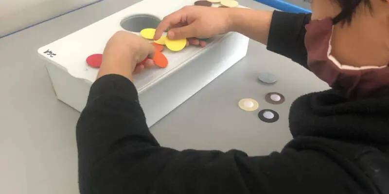 student is working on matching and creating patterns with colors